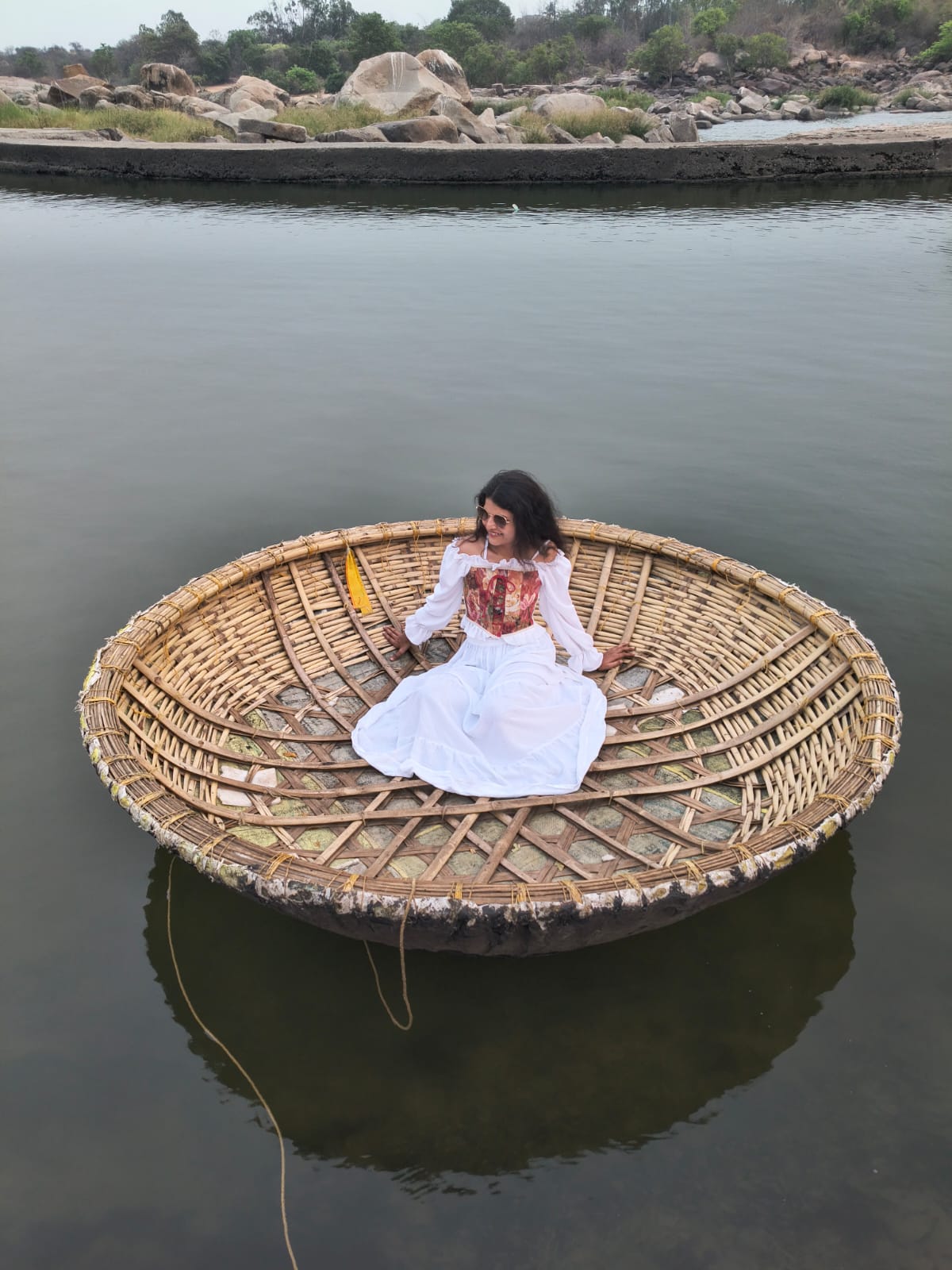 Woman in traditional coracle boat Hampi