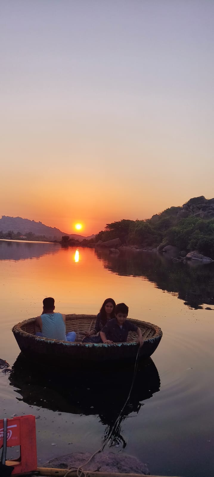Travellers watching sunset from Hampi boulders